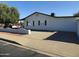 This cozy home features a long driveway, rear windows with black shutters, and a privacy wall at 1922 N 21St Pl, Phoenix, AZ 85006