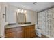 Bathroom with granite counters, wood cabinets, and modern lighting fixtures above the mirror at 200 E Southern Ave # 368, Tempe, AZ 85282