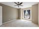 Comfortable bedroom featuring a ceiling fan, soft carpeting and window with privacy drapes at 200 E Southern Ave # 368, Tempe, AZ 85282