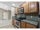 Modern kitchen with stainless steel oven and microwave and wooden cabinets, offering a stylish space at 200 E Southern Ave # 368, Tempe, AZ 85282
