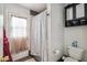 Bathroom featuring tiled shower, toilet, linen closet, and door to backyard at 2009 W Morningside Dr, Phoenix, AZ 85023