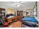 Bedroom with wood floors, full desk, drawers, and bed with blue blanket at 2009 W Morningside Dr, Phoenix, AZ 85023