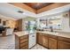 Charming kitchen with granite counters, patterned floors, pool view and brick fireplace at 2009 W Morningside Dr, Phoenix, AZ 85023