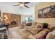Inviting living room with a brick fireplace, plush seating, and bright, natural light from the window at 2009 W Morningside Dr, Phoenix, AZ 85023