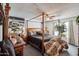 Spacious main bedroom with dark wood furniture, canopy bed and large windows at 2009 W Morningside Dr, Phoenix, AZ 85023