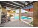 Back patio with shades over pool and seating area at 2009 W Morningside Dr, Phoenix, AZ 85023