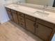 Bathroom vanity featuring double sinks, quartz countertop, and wood cabinets with black hardware at 20346 W Sells Dr, Buckeye, AZ 85396