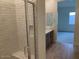 Bright bathroom with a glass-enclosed shower and a vanity with a sink and drawers at 20346 W Sells Dr, Buckeye, AZ 85396