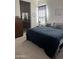 Cozy bedroom with a view of the en-suite bathroom featuring carpet flooring and natural light at 20346 W Sells Dr, Buckeye, AZ 85396