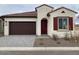 Charming single-story home with red tiled roof, a two-car garage, and desert landscaping at 20346 W Sells Dr, Buckeye, AZ 85396