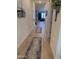 Inviting hallway featuring wood-look tile flooring and access to various rooms of the home at 20346 W Sells Dr, Buckeye, AZ 85396