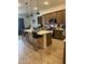 Modern kitchen with a large island, stylish pendant lighting, and stainless steel appliances at 20346 W Sells Dr, Buckeye, AZ 85396