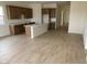 Spacious open concept kitchen and living area featuring wood-look tile flooring at 20346 W Sells Dr, Buckeye, AZ 85396