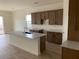 Open kitchen featuring an island with a sink, wood cabinets, and stainless steel appliances at 20346 W Sells Dr, Buckeye, AZ 85396