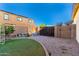 Spacious backyard featuring an artificial lawn and low-maintenance desert landscaping at 21538 E Alyssa Ct, Queen Creek, AZ 85142