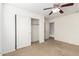 Bedroom featuring neutral carpet, ceiling fan, and closet with sliding doors at 21538 E Alyssa Ct, Queen Creek, AZ 85142