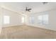 Spacious primary bedroom with carpet, natural light, and a modern ceiling fan with lighting at 21538 E Alyssa Ct, Queen Creek, AZ 85142