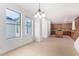 Inviting dining area with tile floor, windows, and stylish chandelier flowing into the kitchen at 21538 E Alyssa Ct, Queen Creek, AZ 85142
