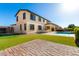 Two-story home showcasing the backyard oasis with pool, patio, and lush green lawn at 21538 E Alyssa Ct, Queen Creek, AZ 85142