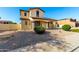 The side exterior showcases the desert landscaping surrounding the charming two-story home at 21538 E Alyssa Ct, Queen Creek, AZ 85142