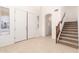 Bright foyer featuring tile flooring, a staircase, and a view into the home at 21538 E Alyssa Ct, Queen Creek, AZ 85142