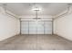 A spacious garage with a white door and an automatic opener at 21538 E Alyssa Ct, Queen Creek, AZ 85142