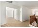 Light-filled upstairs hallway with neutral carpet, white walls, and view of the upstairs bedroom at 21538 E Alyssa Ct, Queen Creek, AZ 85142