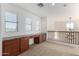 Upstairs loft boasts built-in desk/cabinet space with railing overlooking foyer and lots of natural light at 21538 E Alyssa Ct, Queen Creek, AZ 85142