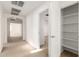 Upstairs hallway featuring carpeted floors, white walls, and a storage closet by the bedroom entry at 21538 E Alyssa Ct, Queen Creek, AZ 85142