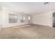 Spacious living room with carpeted floors, neutral color palette and great natural light from multiple windows at 21538 E Alyssa Ct, Queen Creek, AZ 85142
