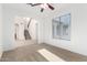 Spacious carpeted area with a large window and an open view of the staircase at 21538 E Alyssa Ct, Queen Creek, AZ 85142