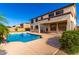 Backyard pool with a view of the two story house and green landscaping at 21538 E Alyssa Ct, Queen Creek, AZ 85142