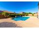 Backyard pool with a blue sky and green trees in the background at 21538 E Alyssa Ct, Queen Creek, AZ 85142