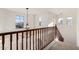 Bright staircase features a decorative chandelier, wood railing, and lots of natural light from the windows at 21538 E Alyssa Ct, Queen Creek, AZ 85142