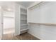 Bright walk-in closet with built-in shelves and rods for efficient storage in neutral colors at 21538 E Alyssa Ct, Queen Creek, AZ 85142