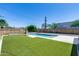 Backyard features a pool, gravel, and synthetic grass at 2336 E Flower St, Phoenix, AZ 85016