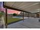 Covered patio leading to a backyard featuring a pool and artificial turf, perfect for outdoor entertaining at 2336 E Flower St, Phoenix, AZ 85016
