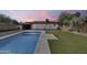 Beautiful pool surrounded by green grass, perfect for entertaining or relaxing in the sun at 2336 E Flower St, Phoenix, AZ 85016