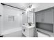 Bathroom features a tiled shower and tub, white vanity, and a modern cabinet at 2336 E Flower St, Phoenix, AZ 85016