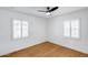 Bright bedroom with two windows with white blinds and beautiful wood flooring at 2336 E Flower St, Phoenix, AZ 85016