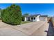 Home's white exterior with modern garage door and long driveway is a must see! at 2336 E Flower St, Phoenix, AZ 85016