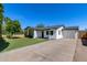 Beautiful home with a well-manicured lawn, mature trees, and a charming white picket fence at 2336 E Flower St, Phoenix, AZ 85016