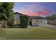 Charming home with green lawn, mature landscaping, and freshly painted white exterior at 2336 E Flower St, Phoenix, AZ 85016