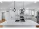 Bright kitchen boasts white cabinetry, quartz counters, and a stylish mosaic backsplash at 2336 E Flower St, Phoenix, AZ 85016