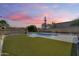 Backyard features a modern pool surrounded by lush artificial turf, ideal for outdoor relaxation and enjoyment at 2336 E Flower St, Phoenix, AZ 85016