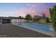 This backyard features a modern pool, low-maintenance landscaping, and a patio, perfect for outdoor gatherings at 2336 E Flower St, Phoenix, AZ 85016