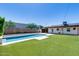 Inviting pool and manicured lawn, creating an outdoor oasis perfect for relaxation and entertaining in this backyard at 2336 E Flower St, Phoenix, AZ 85016
