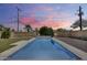 A refreshing pool set in a well-maintained backyard with lush artificial turf and modern stone features at 2336 E Flower St, Phoenix, AZ 85016