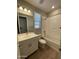 Bathroom features a single sink, tub/shower, and wood-look floors at 24146 N 162Nd Ln, Surprise, AZ 85387