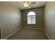 Neutral bedroom features include a ceiling fan, carpet floors and a window at 24146 N 162Nd Ln, Surprise, AZ 85387